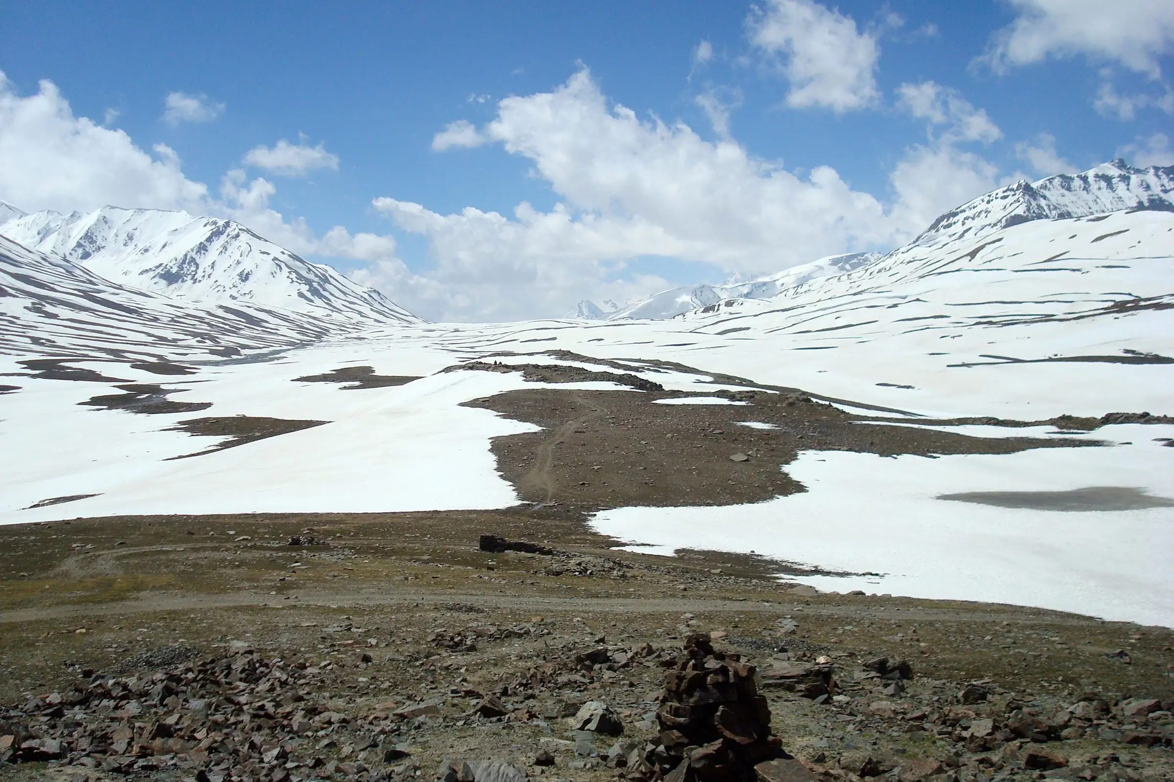 Snowfields and a stone cairn on the Baralacha La plateau, looking from Baralacha La North towards Baralacha La South, the end of the trek