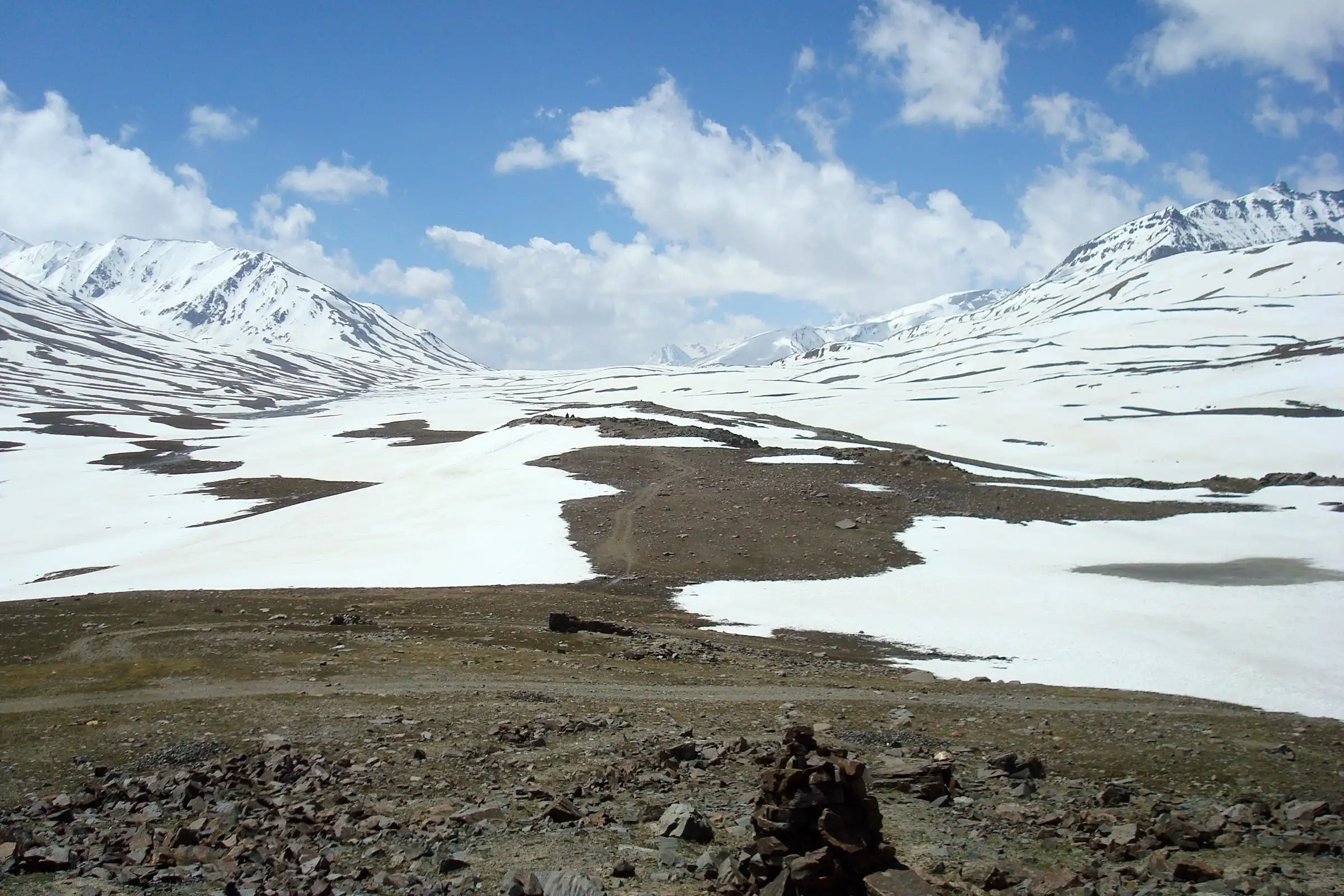 Snowfields and a stone cairn on the Baralacha La plateau, looking from Baralacha La North towards Baralacha La South, the end of the trek