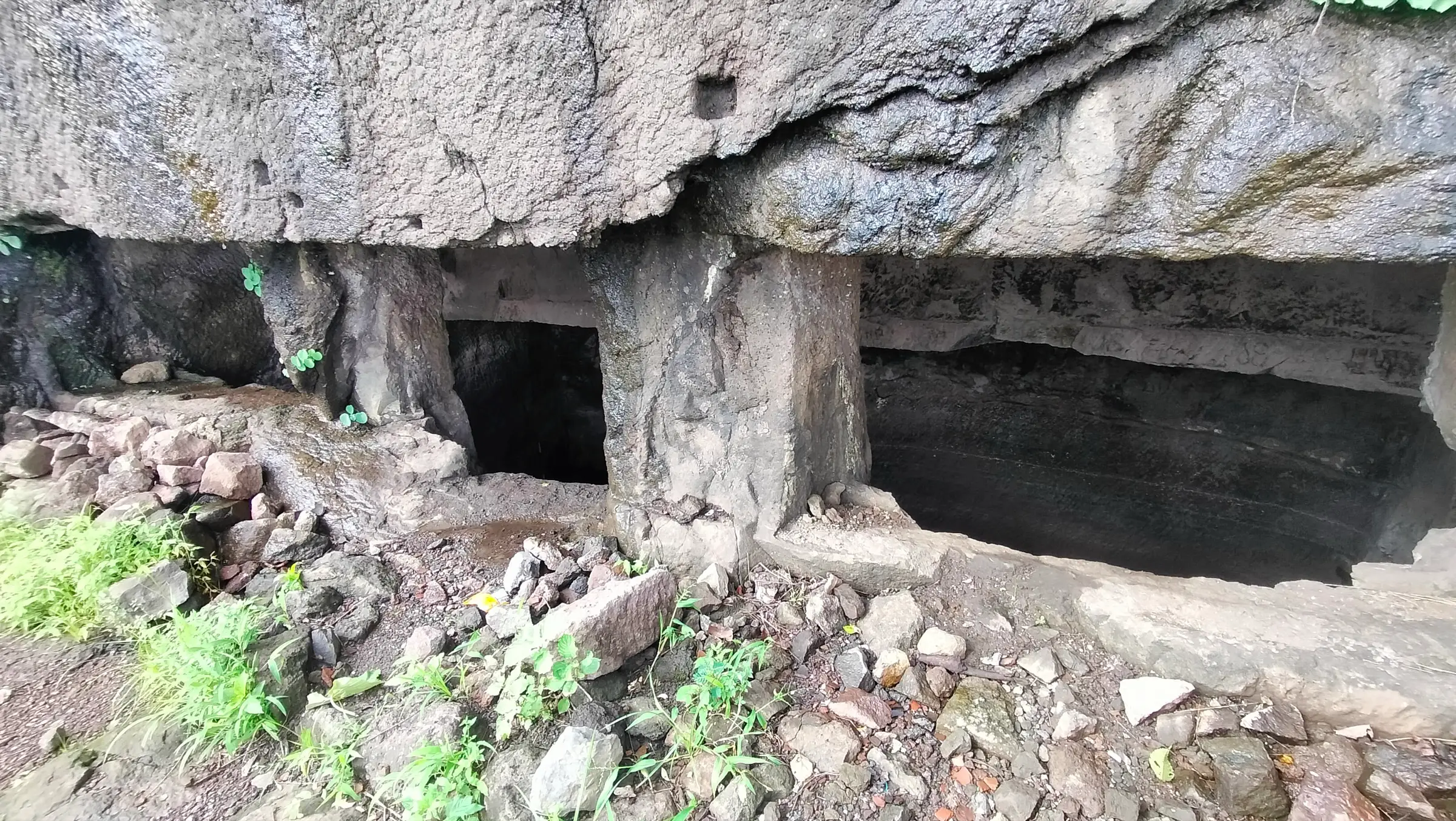 Pillared rock-cut water cistern carved under an overhanging rock on Sankshi Fort