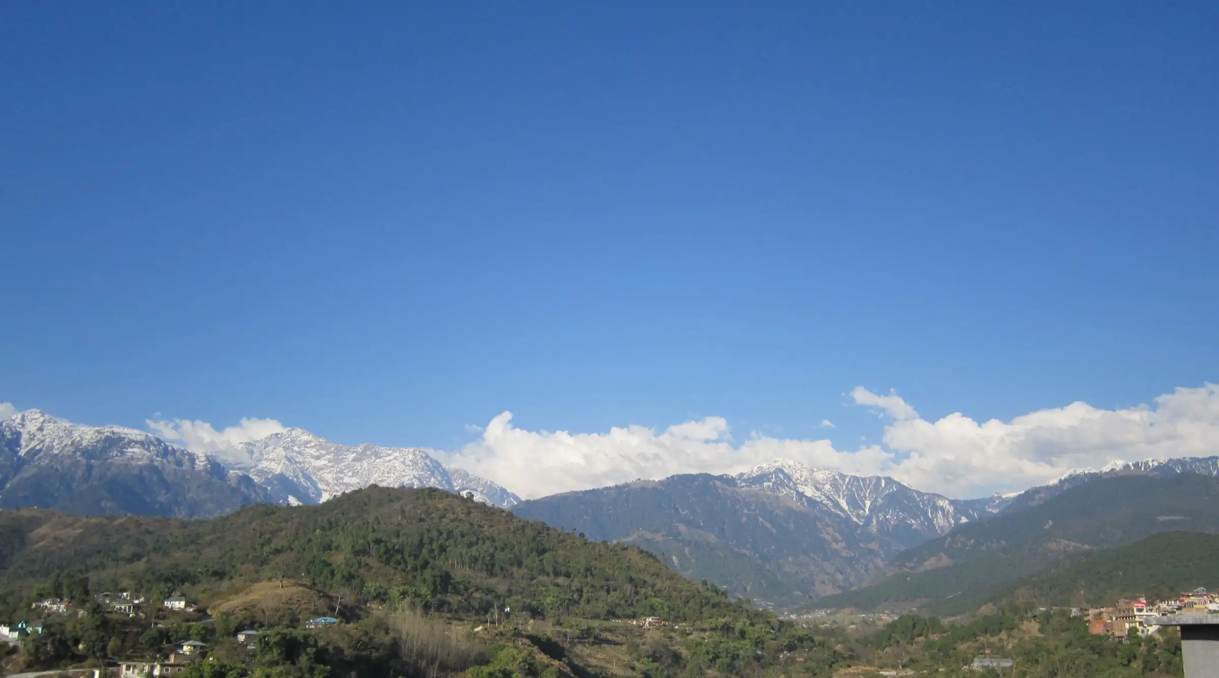 Snow-streaked Dhauladhar range above green hills, seen from Baijnath, near the start of the trek (not the trek itself)
