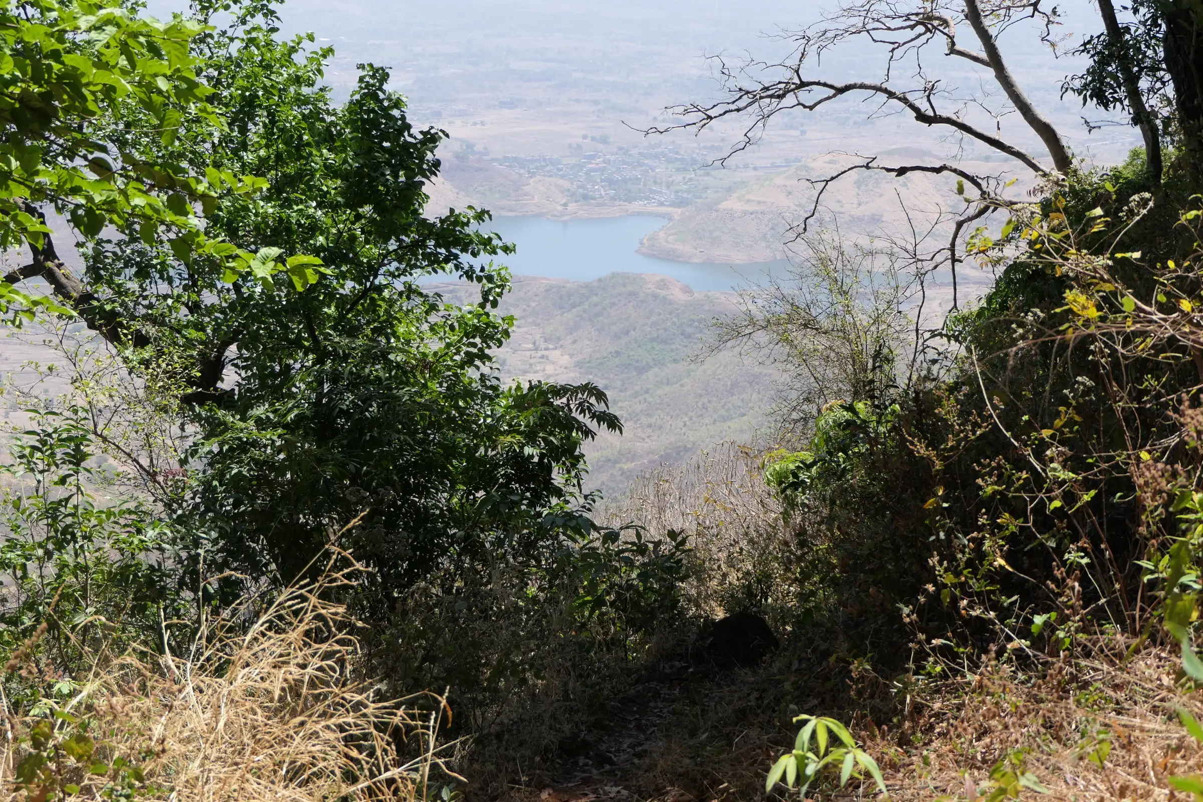 Dhom lake and the surrounding farmland seen from the Garbett trail on a hazy dry-season day
