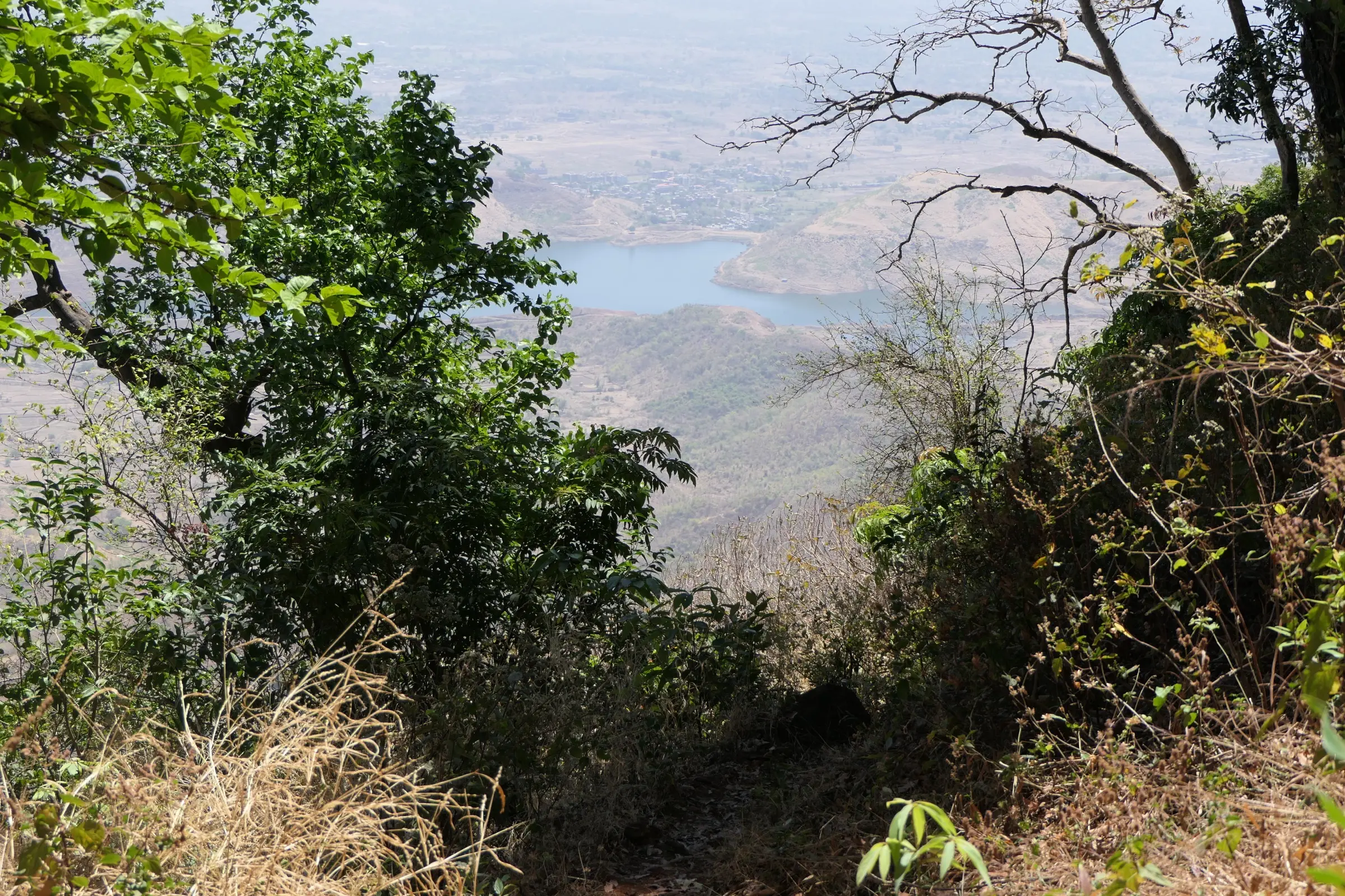 Dhom lake and the surrounding farmland seen from the Garbett trail on a hazy dry-season day