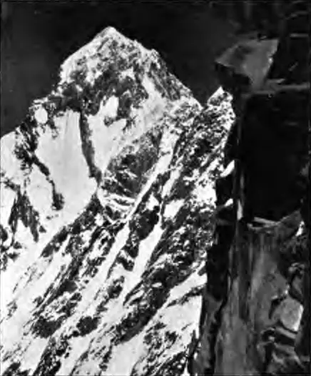 Black-and-white photograph of the rocky, snow-streaked Dunagiri peak seen from the Bagini Pass at the head of the Bagini Glacier