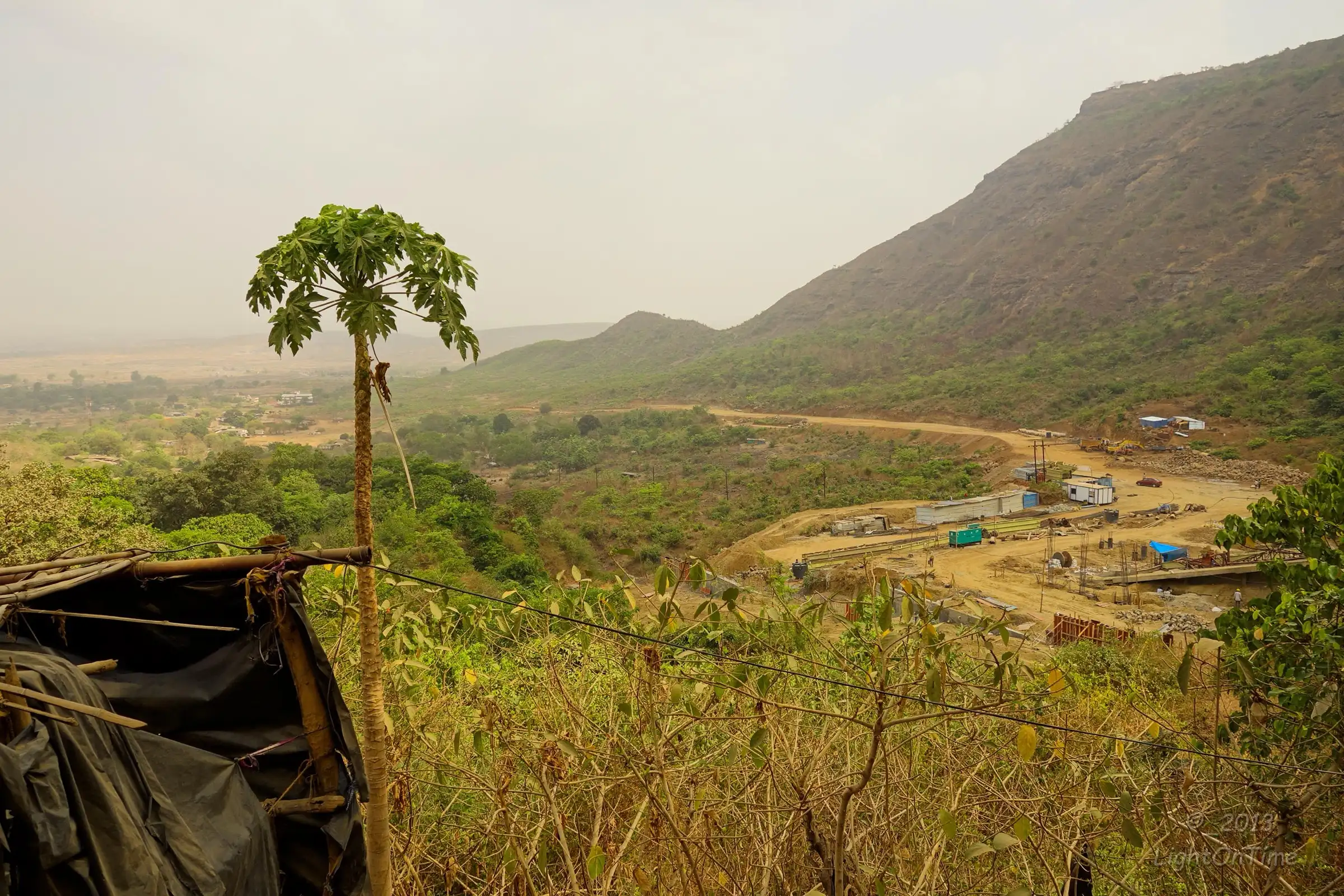 View from the lower slopes of Malanggad over the plains and the steep hillside near Tahuli; the photo shows the area around the trek, not Tahuli itself