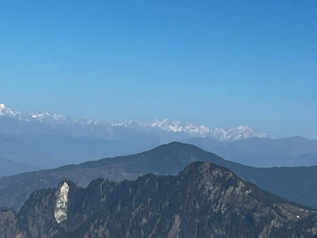 Snow-capped Himachal Himalaya above forested ridges, seen from the Shali Mata Temple on Shali Tibba