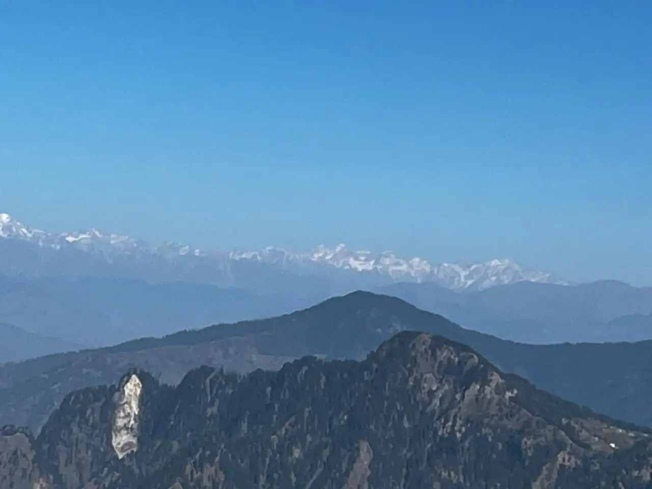 Snow-capped Himachal Himalaya above forested ridges, seen from the Shali Mata Temple on Shali Tibba