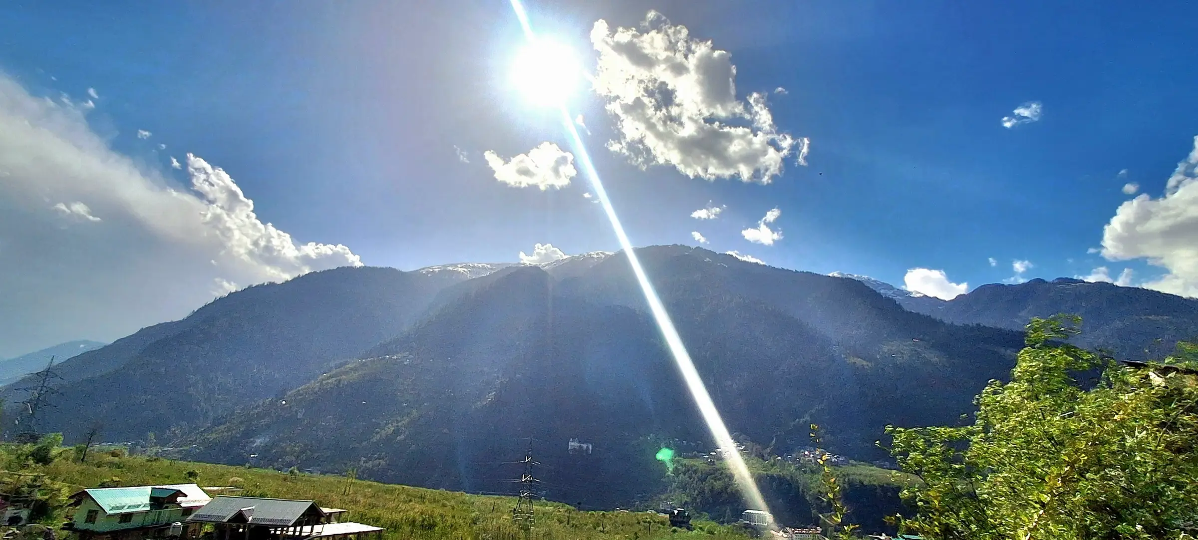 Forested mountains above Jagatsukh village near Manali in sunshine; the hills around the start of the climb, not the route itself