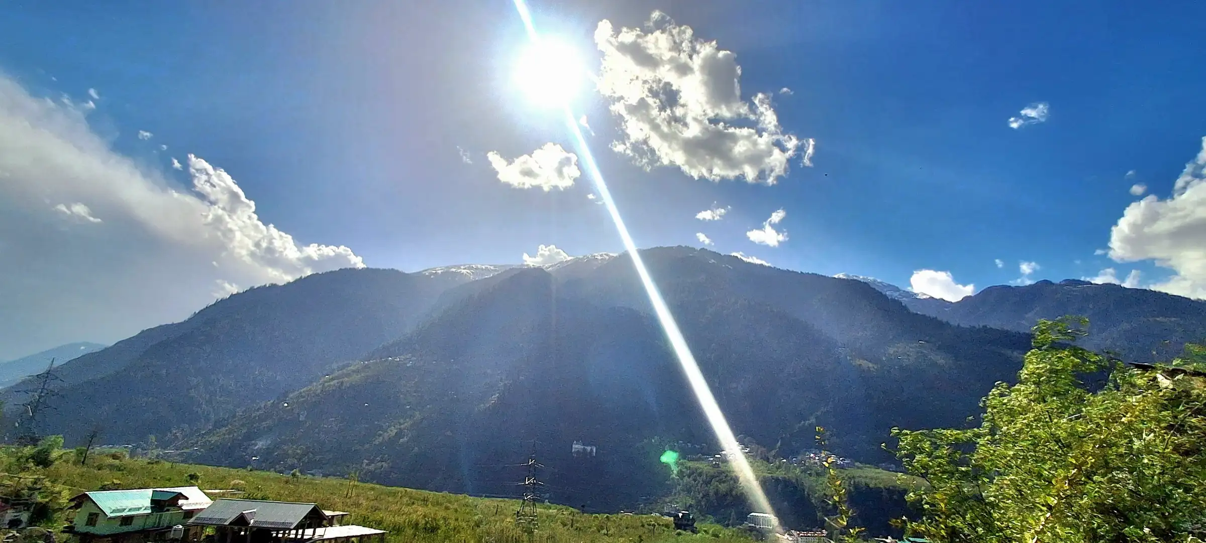 Forested mountains above Jagatsukh village near Manali in sunshine; the hills around the start of the climb, not the route itself