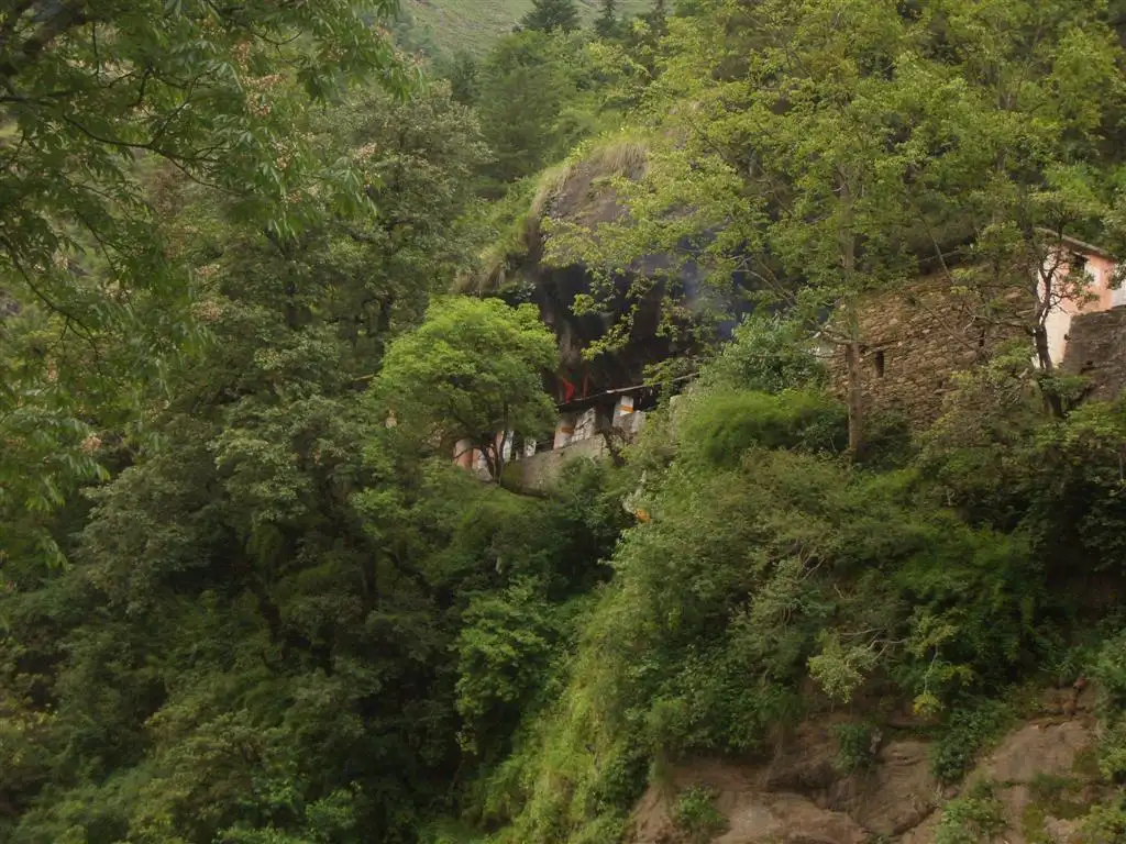 The Kalpeshwar temple tucked under a rock cave in thick forest on a steep hillside