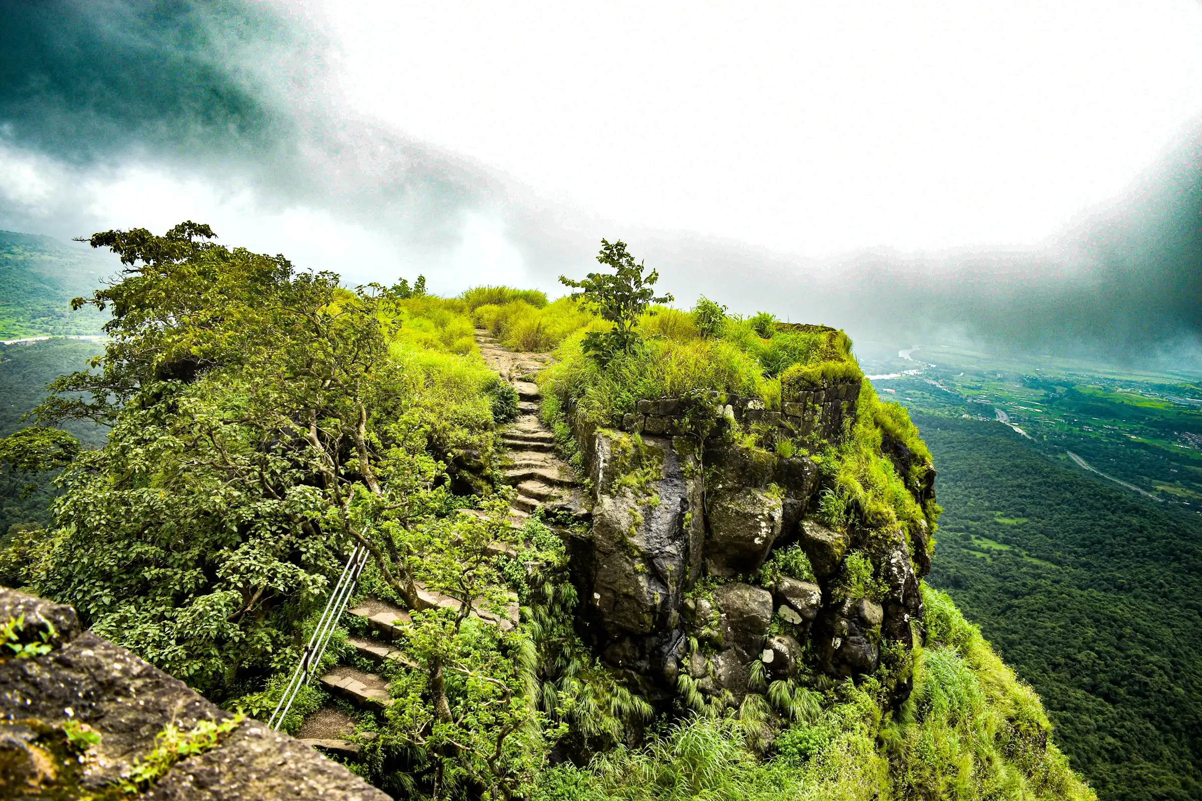 Monsoon view from the top of Karnala Fort over green forest and valley, the neighbouring hill whose pinnacle the Ransai trail looks up at; not the Ransai trail itself