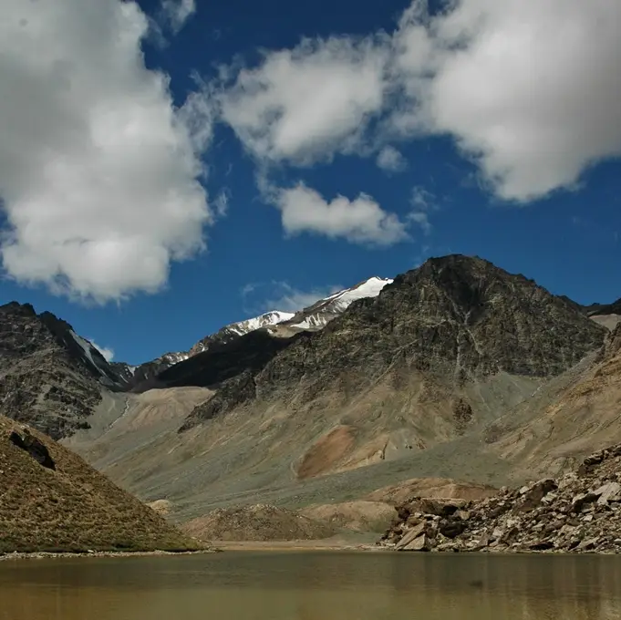 Pool and bare hills beside the Manali-Leh highway at Kilang Sarai, the starting point of the trek