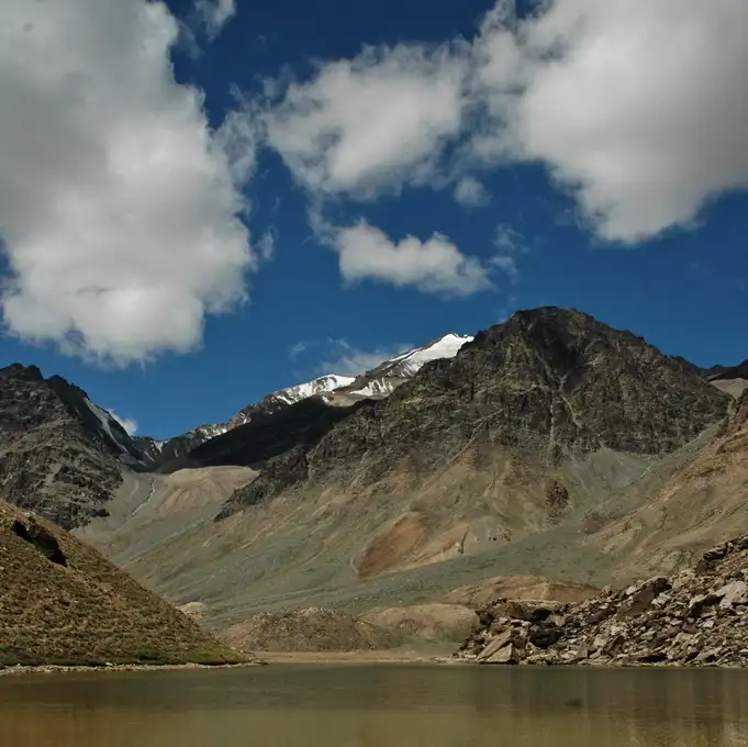 Pool and bare hills beside the Manali-Leh highway at Kilang Sarai, the starting point of the trek