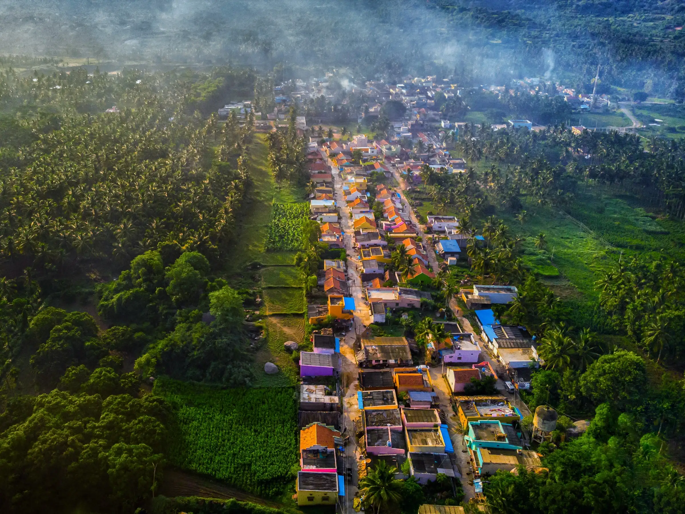 Aerial view of Koothagal village among coconut groves and wooded hills in Ramanagara district, about 6 km from Narayanagiri (not the trek itself)