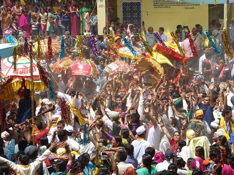 Crowd of devotees with decorated chhantoli umbrellas welcoming the Raj Jat at Kulsari village in 2014