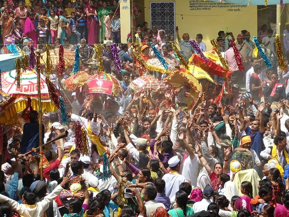 Crowd of devotees with decorated chhantoli umbrellas welcoming the Raj Jat at Kulsari village in 2014