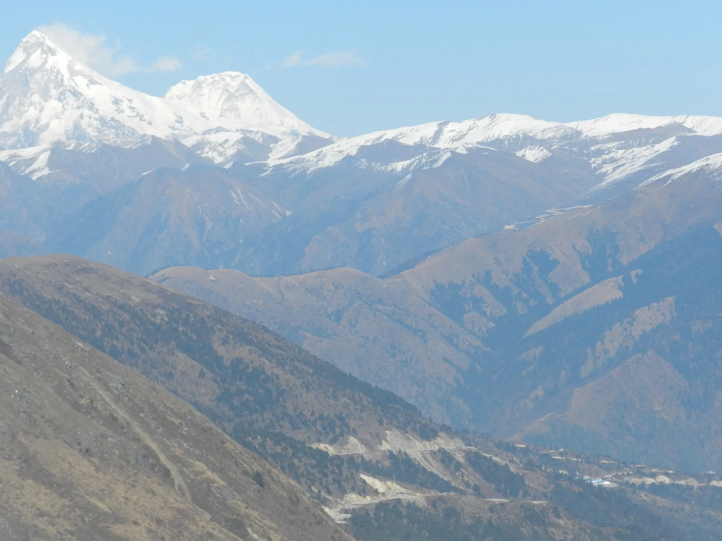 View from Malana over the Malana valley to the snow peaks of Indrasan and Deo Tibba, the area where the Gwaru Pass trek ends (not the pass itself)
