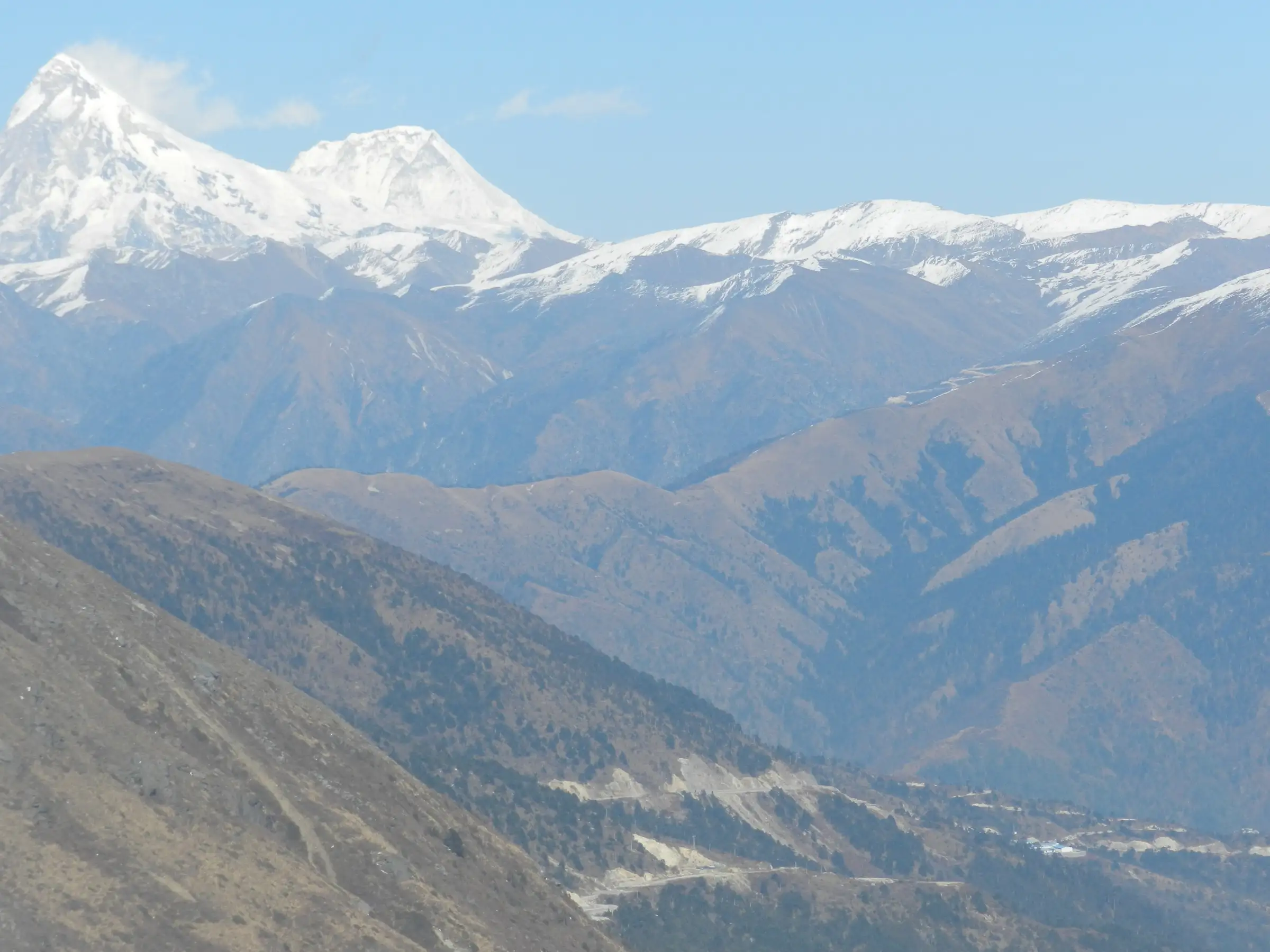 View from Malana over the Malana valley to the snow peaks of Indrasan and Deo Tibba, the area where the Gwaru Pass trek ends (not the pass itself)