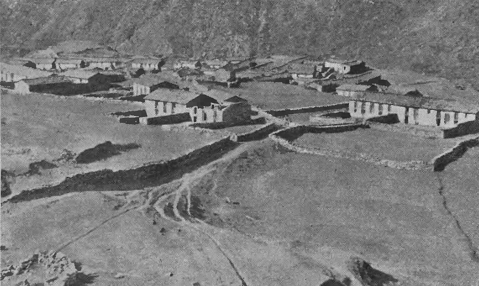 Black-and-white 1939 photograph of the stone houses and walled fields of Martoli village in the Johar valley