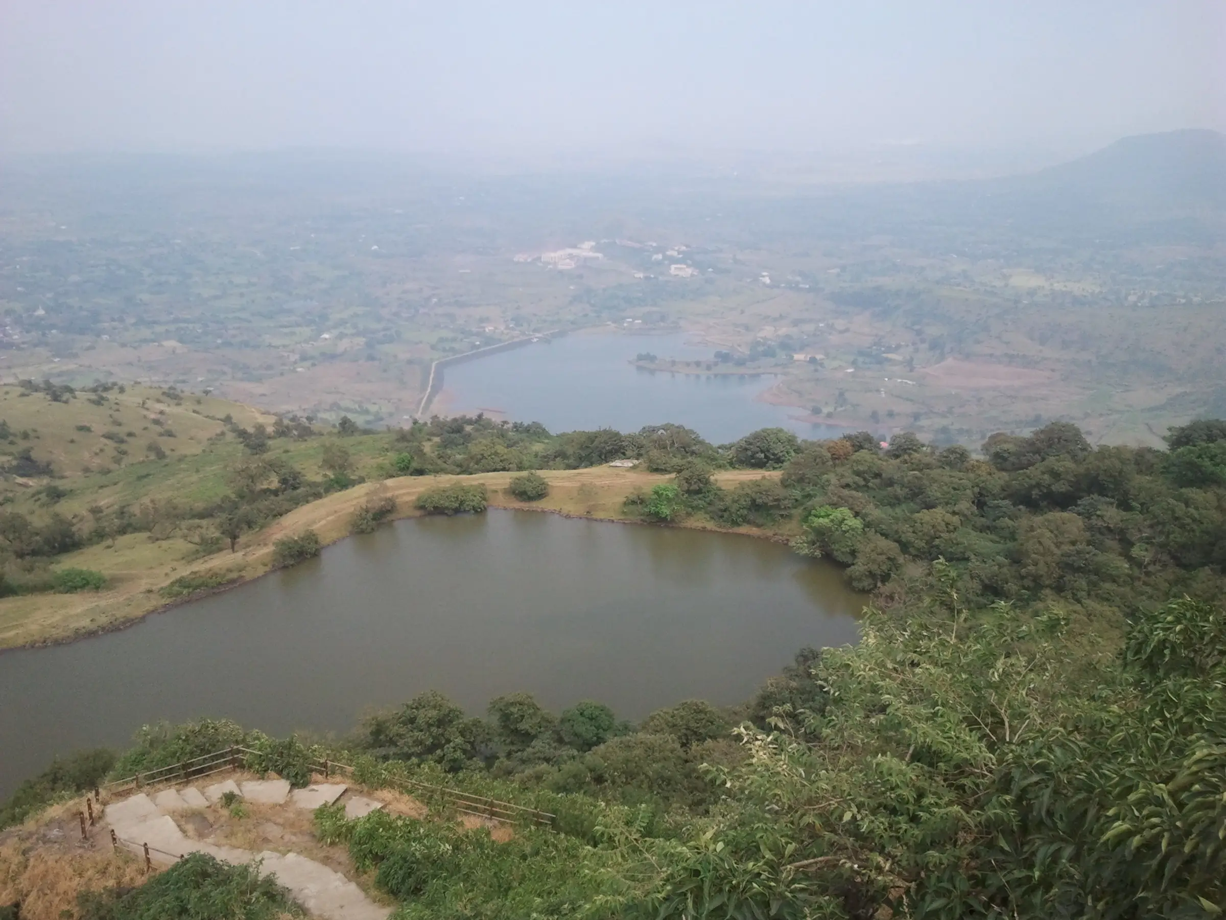 The foot-shaped lake and Anjaneri Lake beyond it, seen from the stone steps near the top of Anjaneri