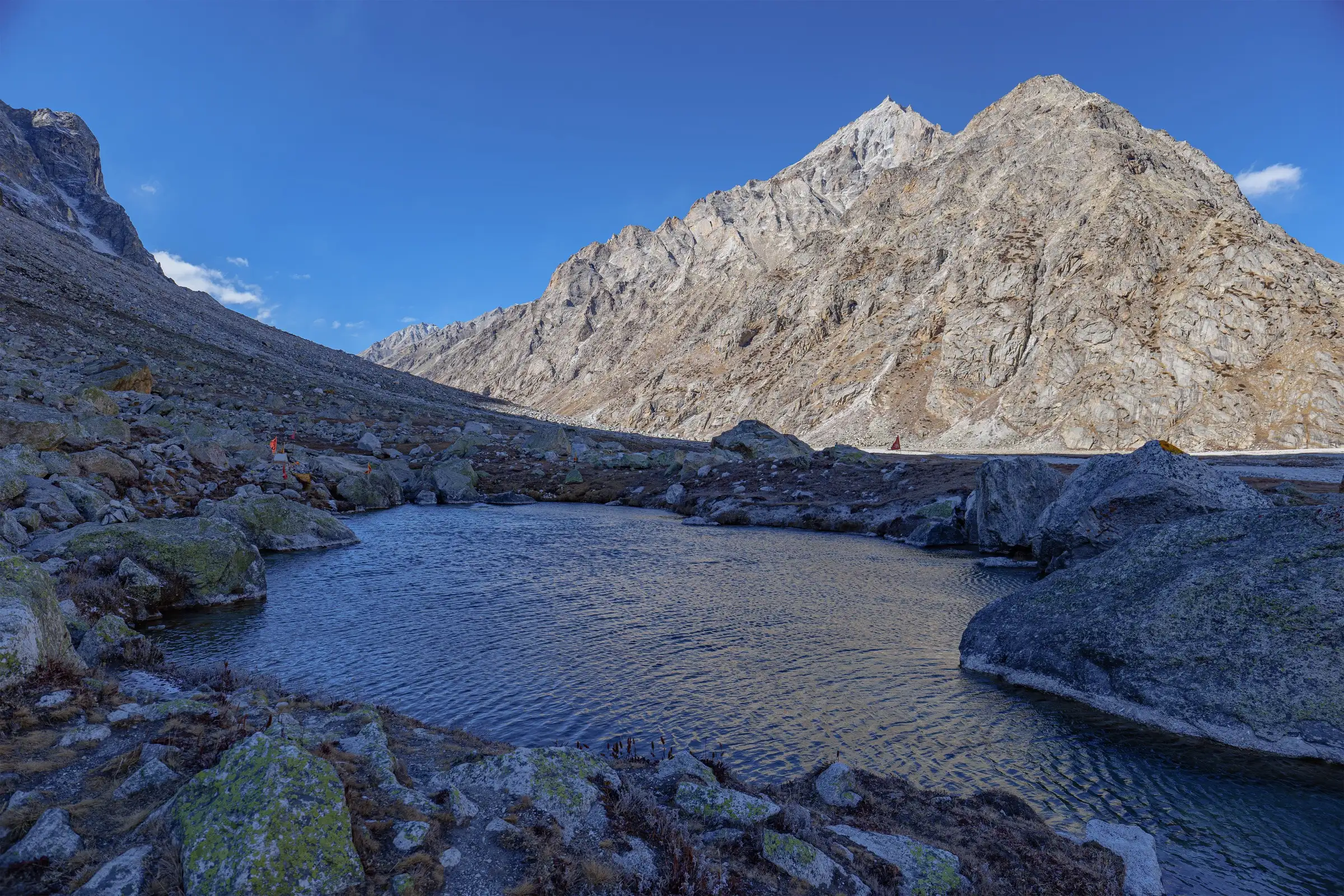 Nag Tal, a small boulder-ringed lake near Ghastoli in the Mana valley, below bare rock peaks