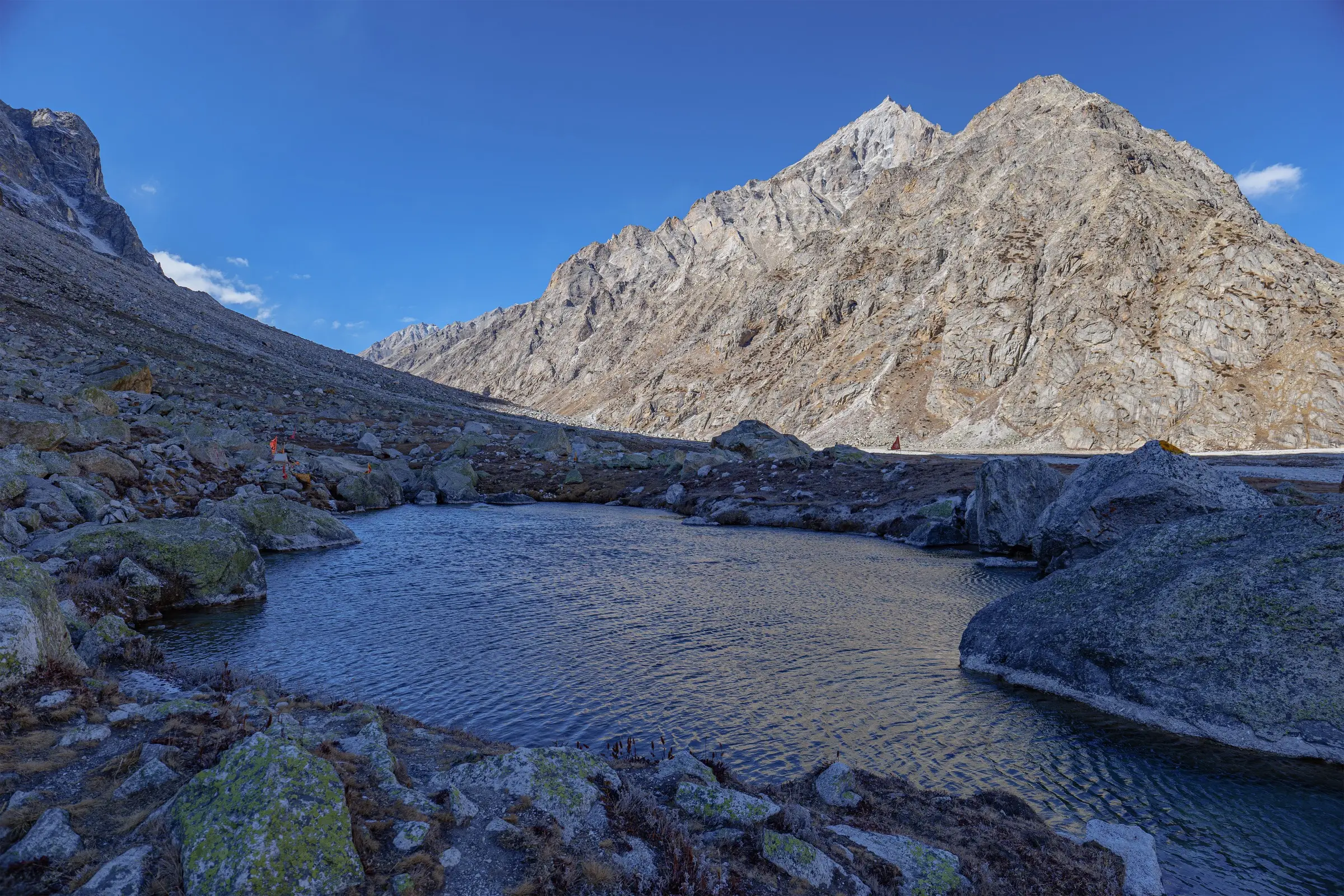 Nag Tal, a small boulder-ringed lake near Ghastoli in the Mana valley, below bare rock peaks