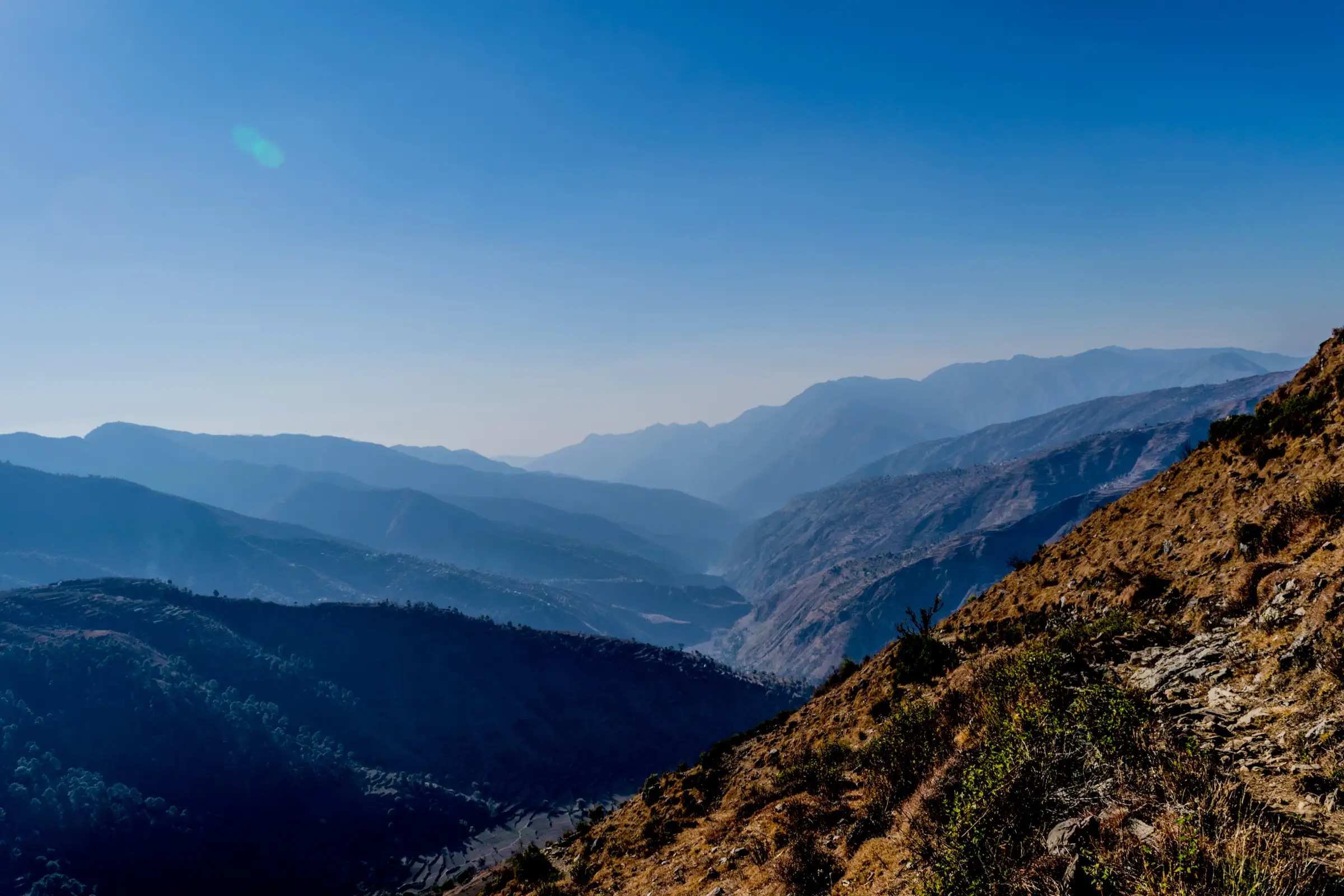 Layers of hazy blue ridges seen from the Nag Tibba range, a few kilometres east of Saindul and Nag Thatch
