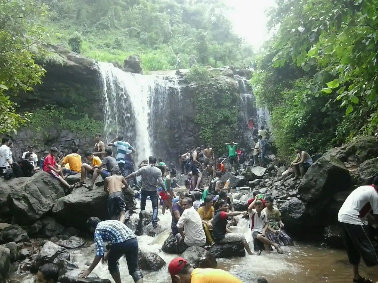 Monsoon waterfall at Palasdari with crowds of visitors, near the Songiri trek
