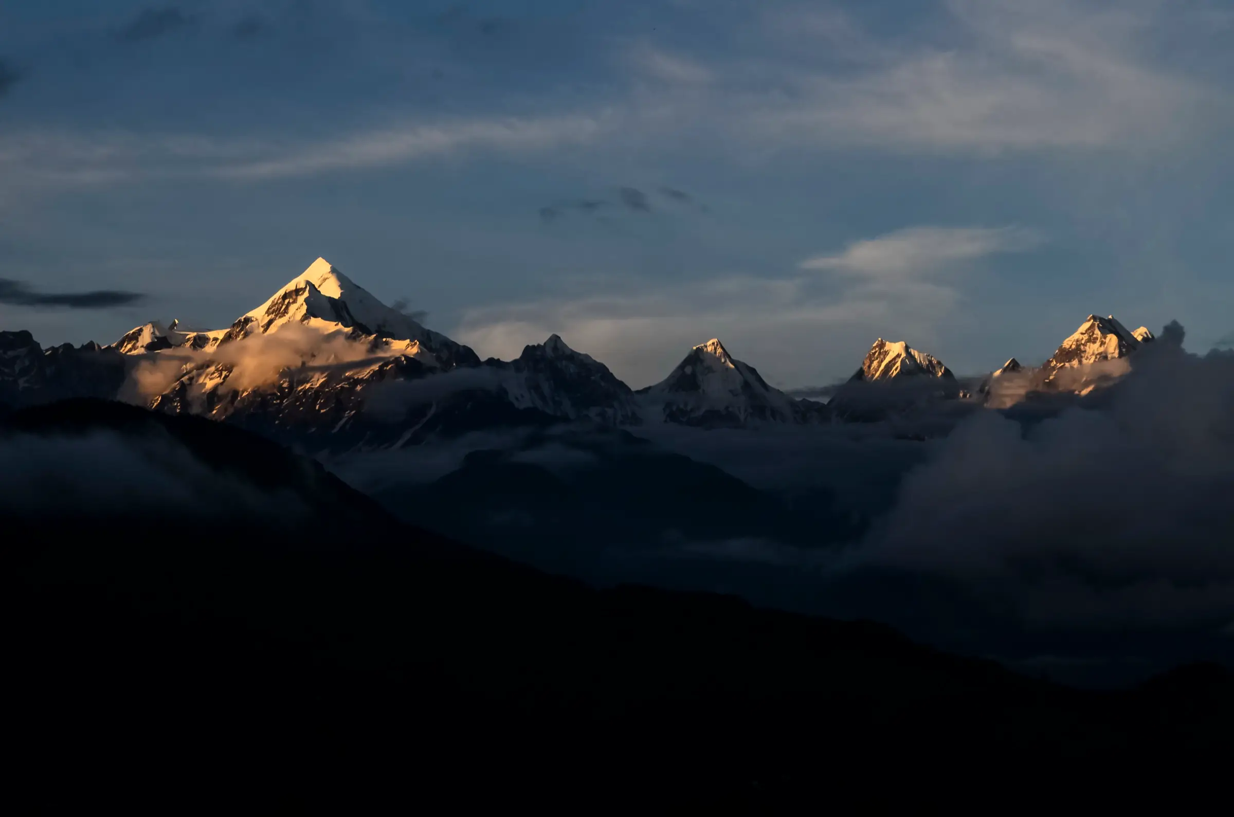 Panchachuli peaks lit by the first sun above a sea of cloud, seen from Munsiyari, the road head for the Brij Ganga Pass trek