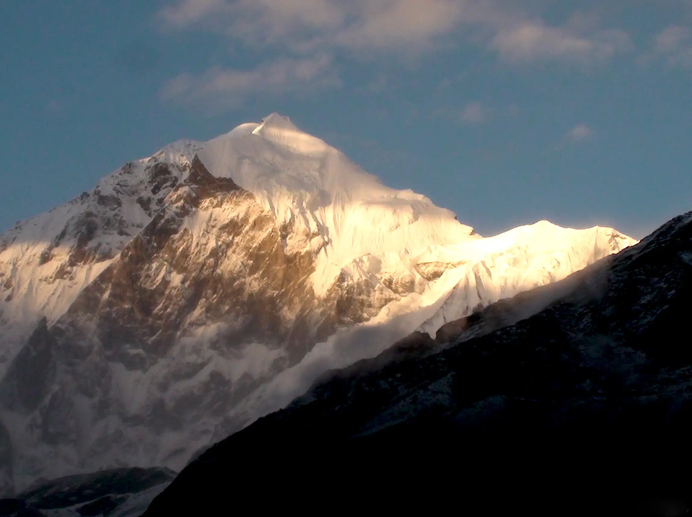 Golden evening light on the snowy summit of Mount Pandim seen from the Thansing campsite
