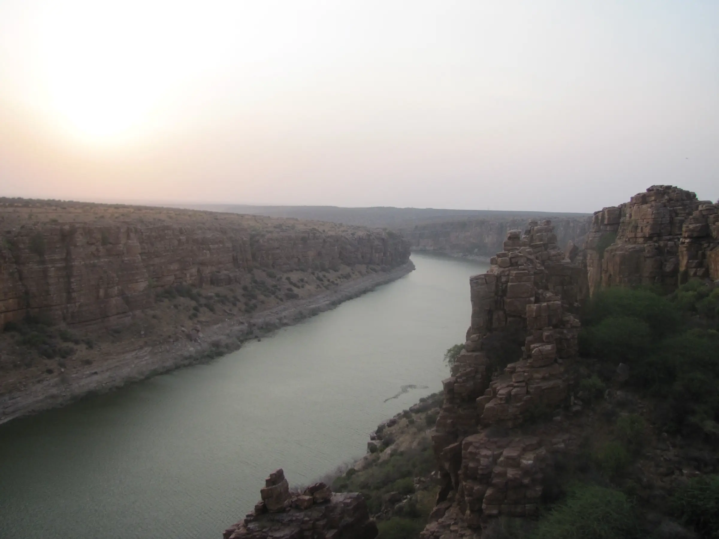 Evening light over the Penna river gorge at Gandikota, with stacked rock towers in the foreground