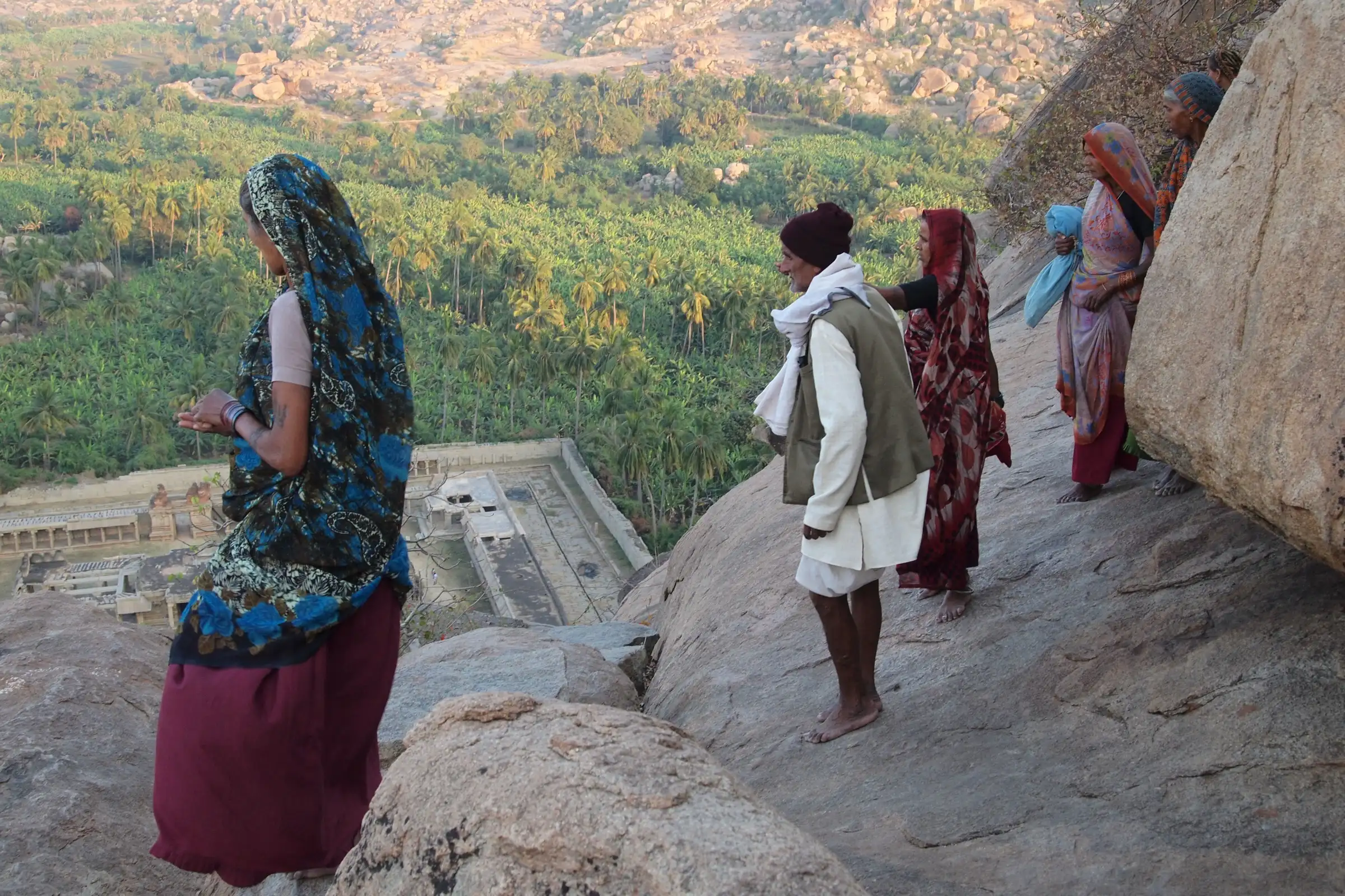 Pilgrims walking down the bare granite slope of Matanga Hill towards the Achyutaraya temple below