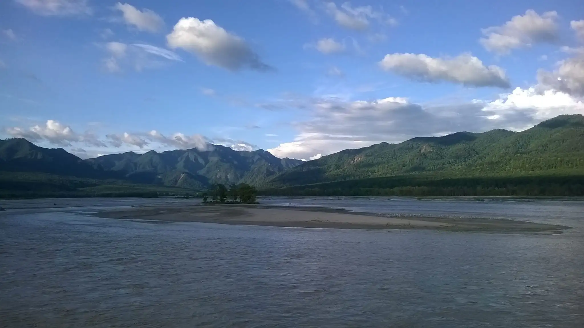 The forested Purnagiri hills behind the wide Sharda river and a sandbar, seen from the barrage road at Tanakpur
