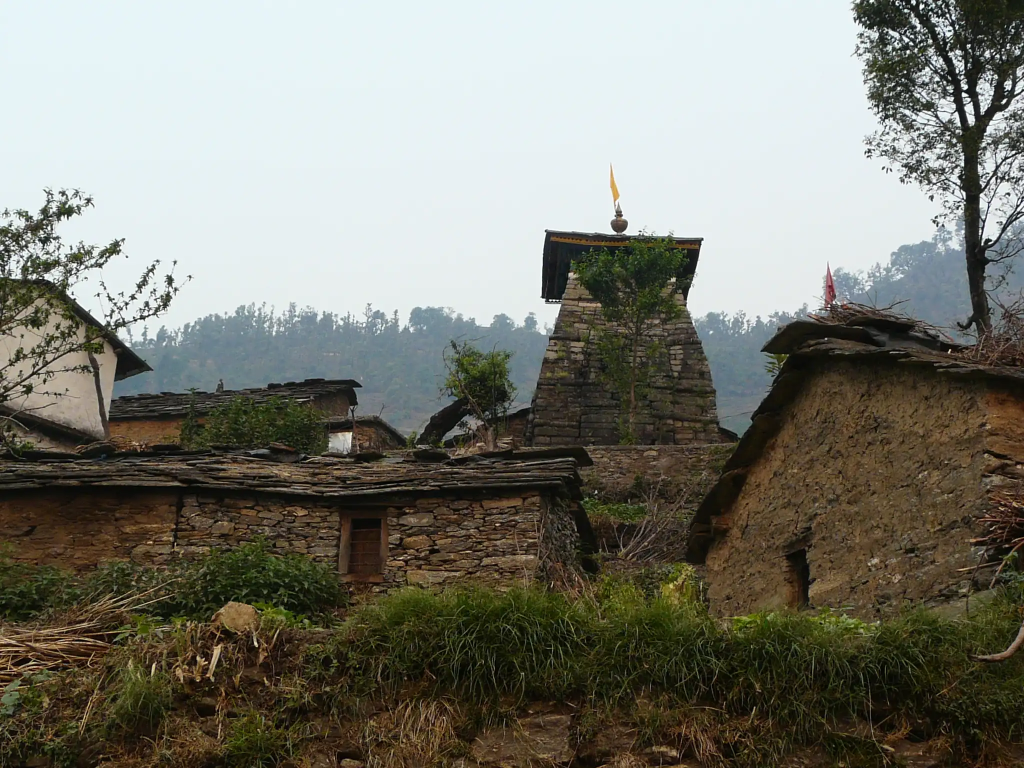 Stone huts and the Rakeshwari temple at Ransi, the road-head village where the Mandani valley trek begins