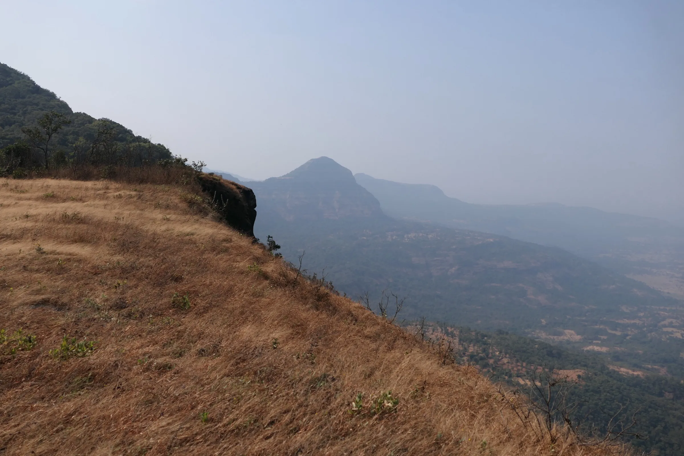 Dry grassy slope and a rounded hill above the valley near Sakhalewadi, about 4 km from Lingya Ghat (surrounding area, not the trek itself)