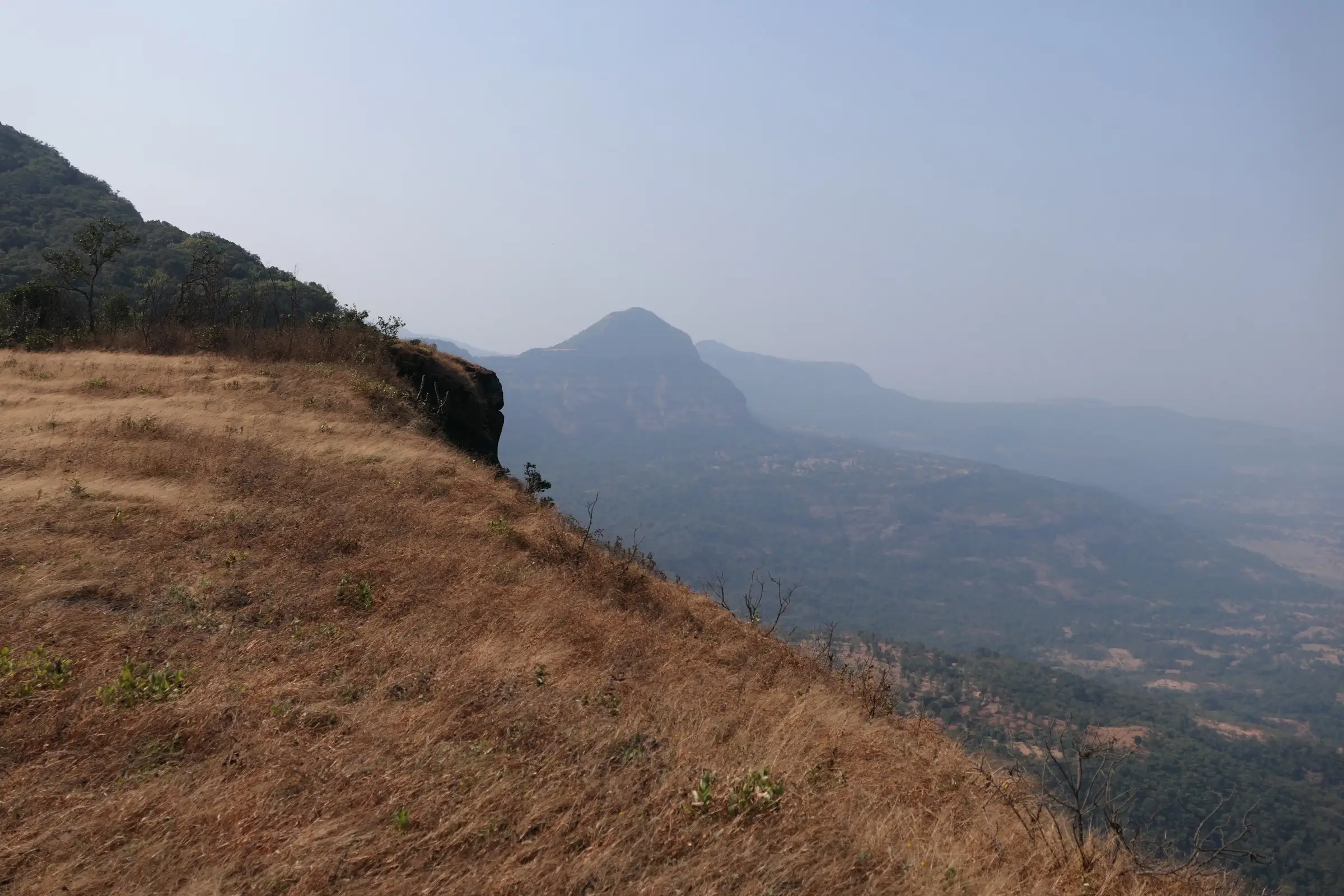 Dry grassy slope and a rounded hill above the valley near Sakhalewadi, about 4 km from Lingya Ghat (surrounding area, not the trek itself)