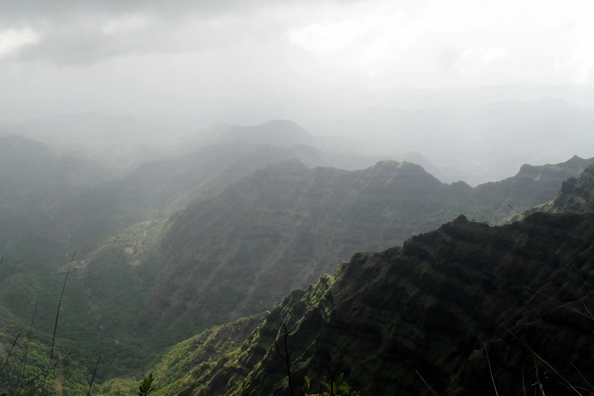 Rain clouds over the layered green ridges of the Savitri valley below Arthur's Seat