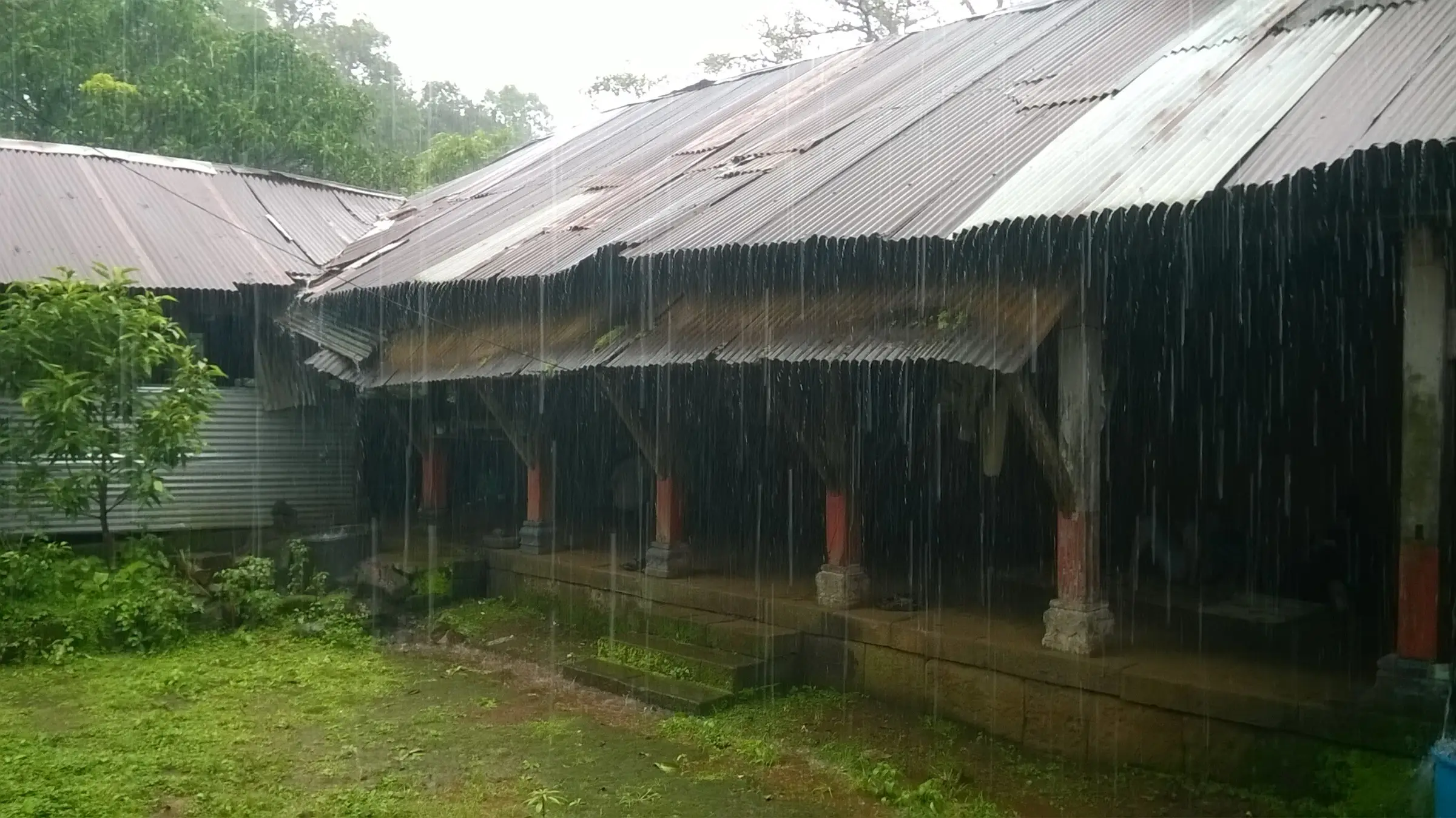 Pant Sachiv Wada on Sudhagad with its tin roof and wooden pillars in heavy rain