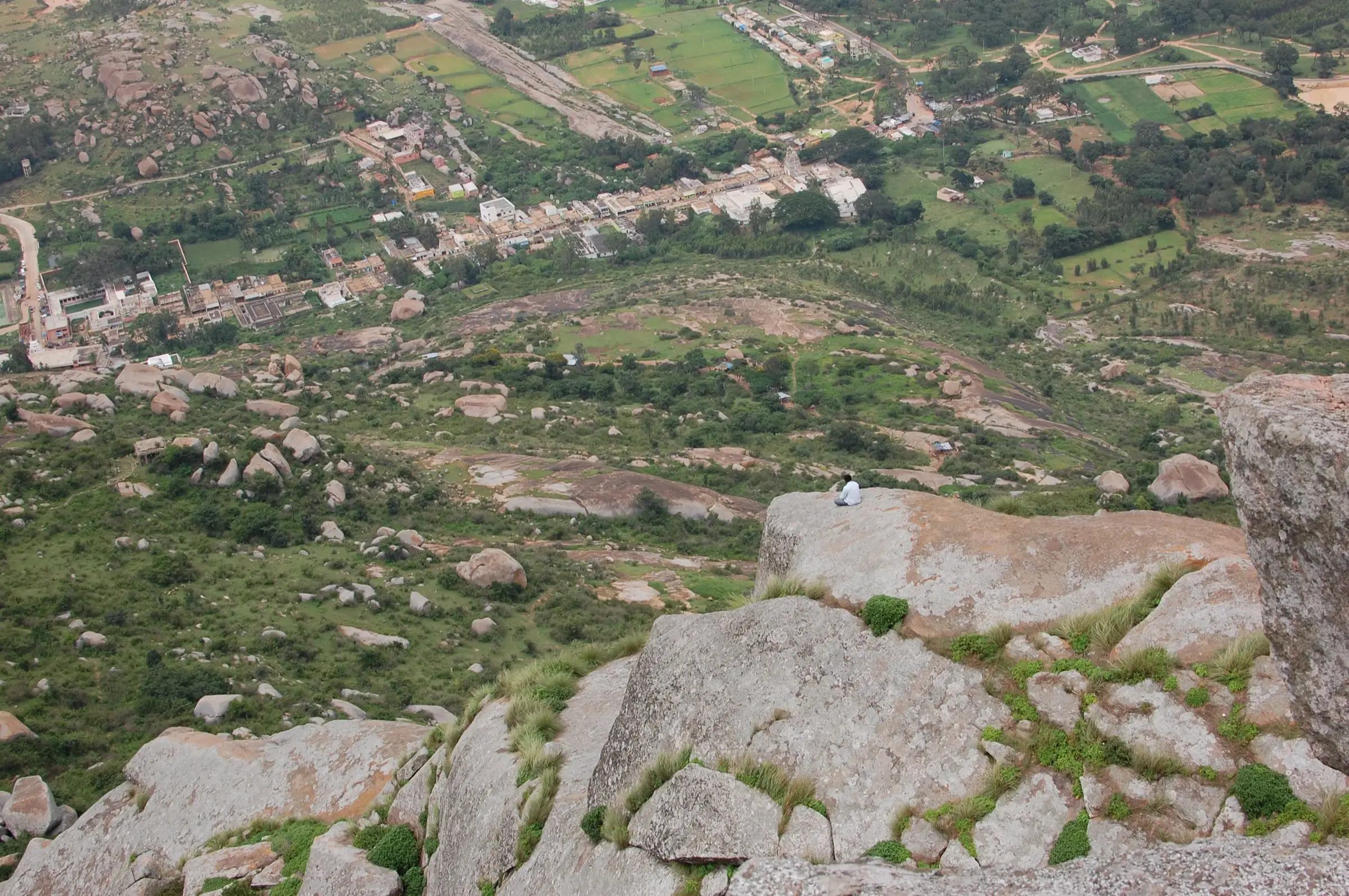 View down from the top of Shivagange hill over granite slabs to Shivagange village, fields and scattered boulders