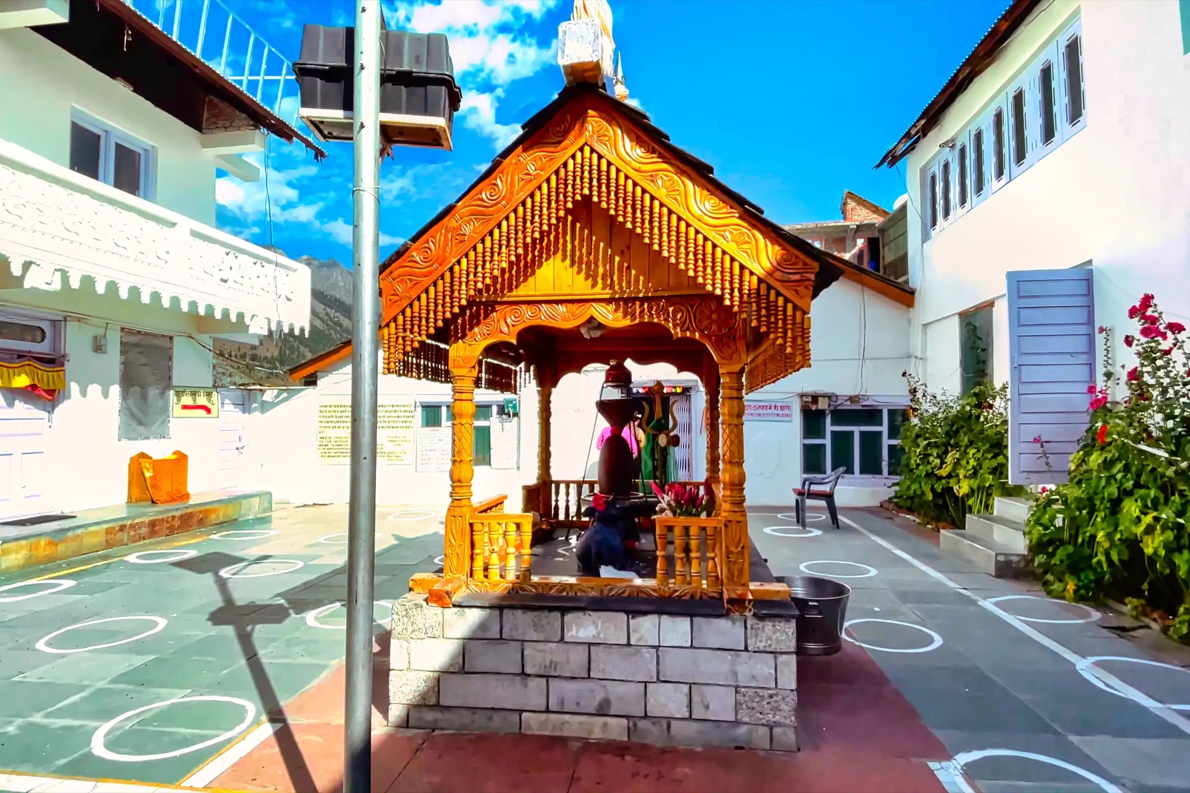 A carved wooden shrine in the courtyard of the Trilokinath temple complex in Lahaul, where the trek ends after the pass