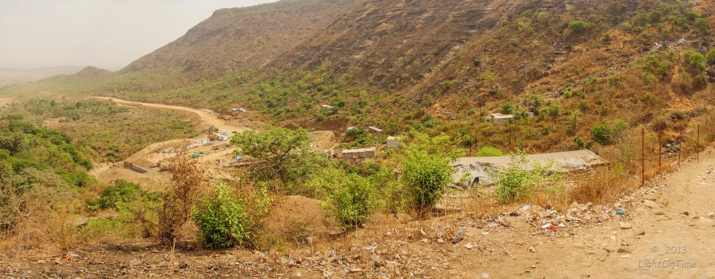 Dry-season view of the forested hill slopes and the valley below Malanggad, the neighbouring hill that faces Tahuli; the photo does not show Tahuli itself