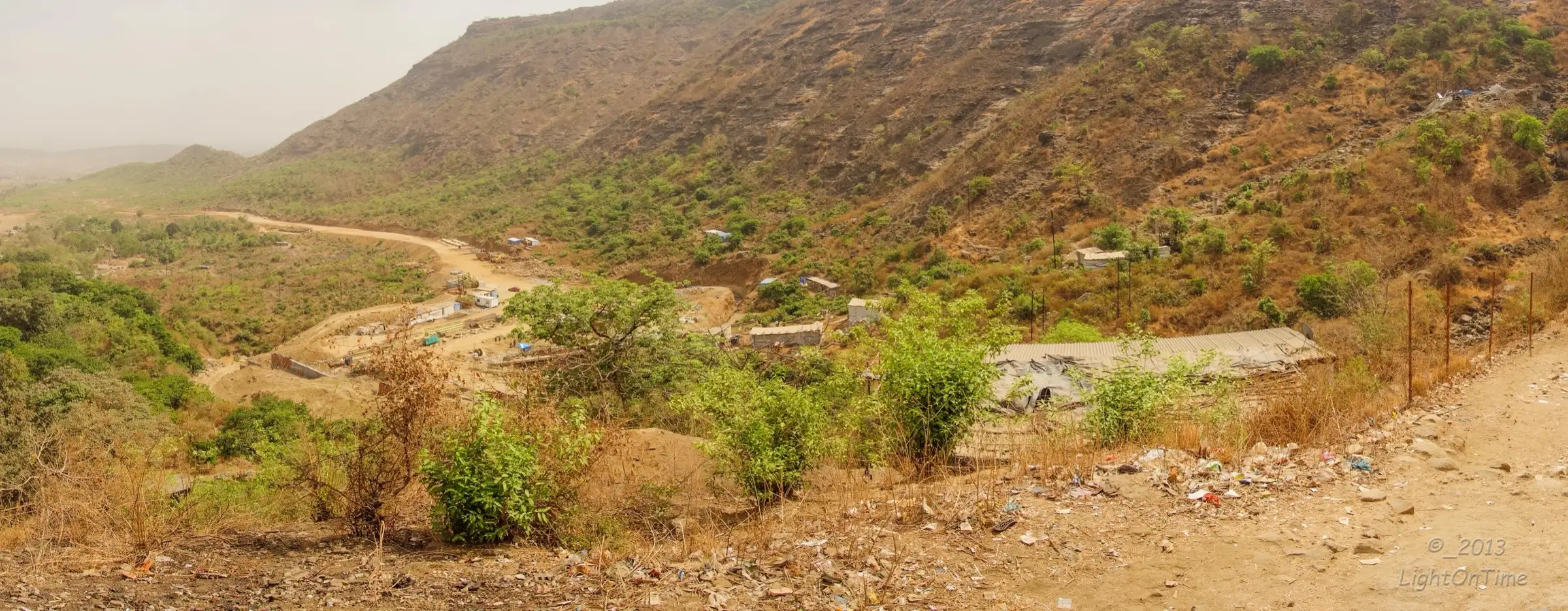 Dry-season view of the forested hill slopes and the valley below Malanggad, the neighbouring hill that faces Tahuli; the photo does not show Tahuli itself