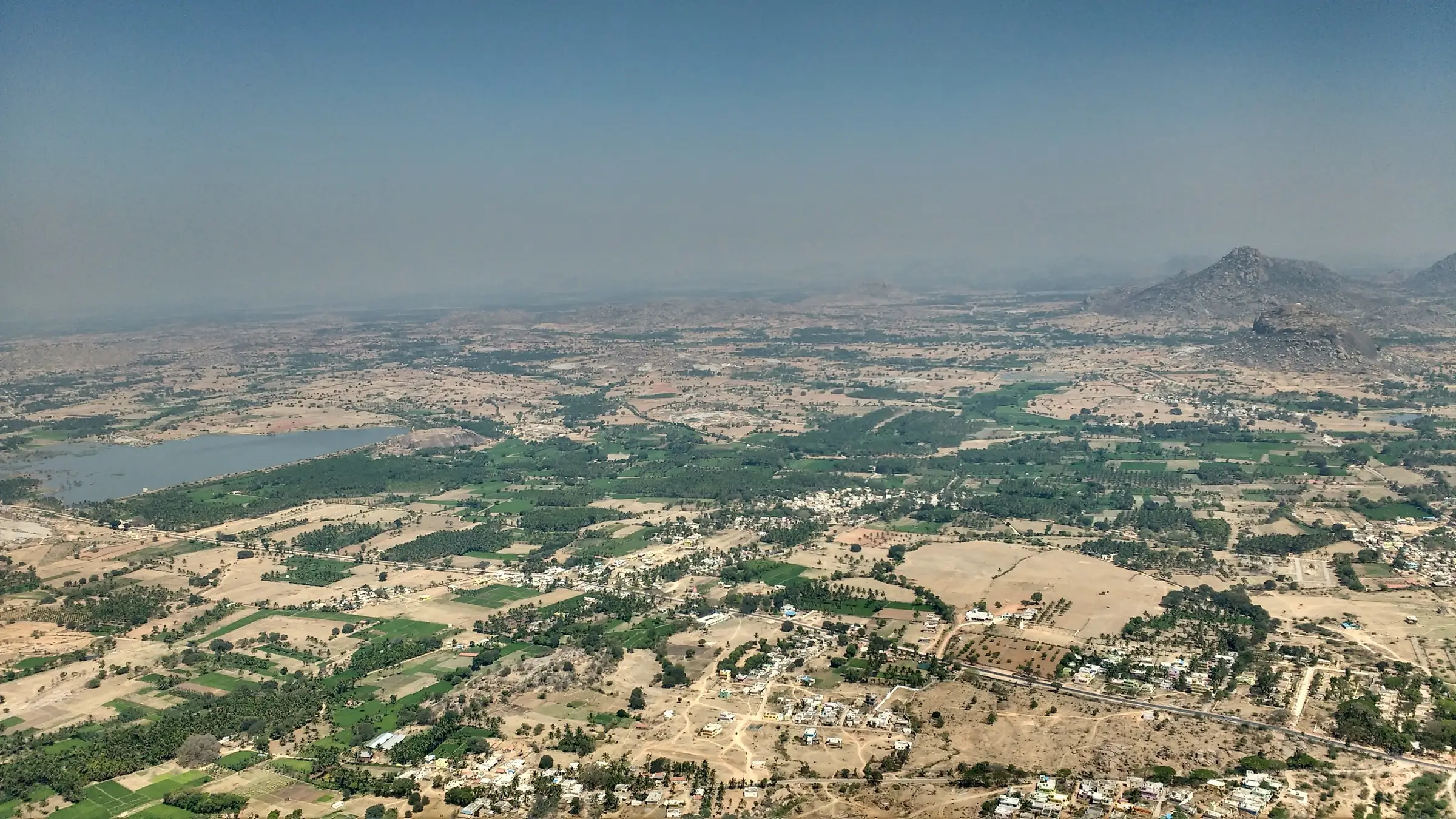 View from the top of Madhugiri fort over Madhugiri town, farmland, a lake and distant rocky hills