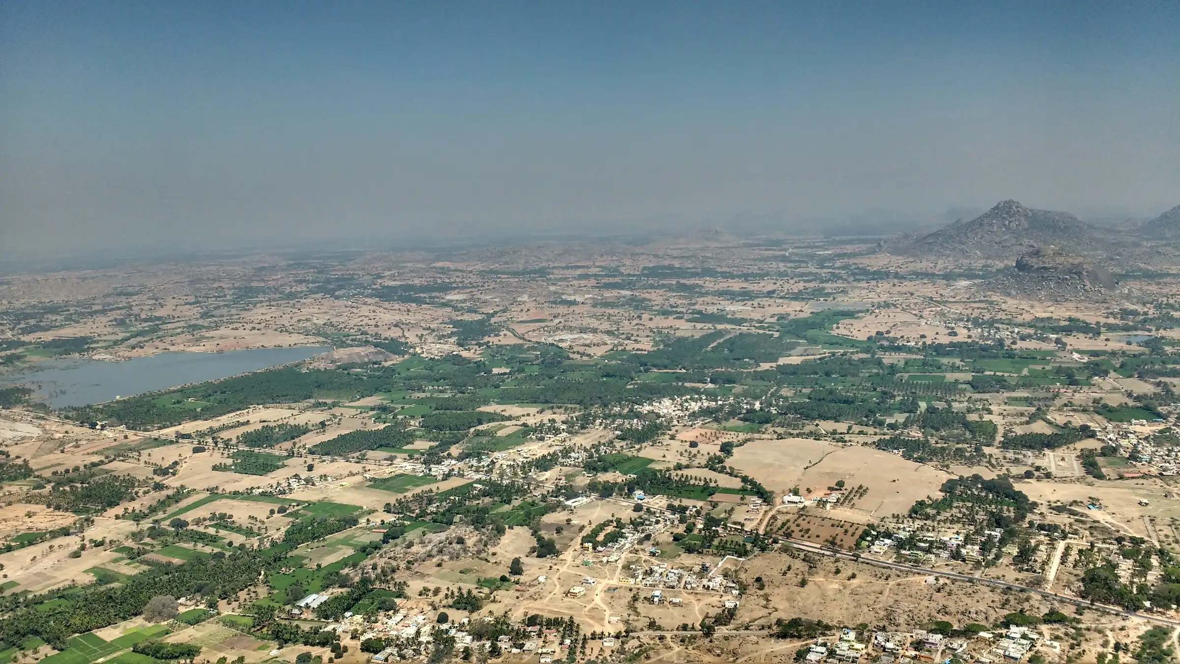 View from the top of Madhugiri fort over Madhugiri town, farmland, a lake and distant rocky hills