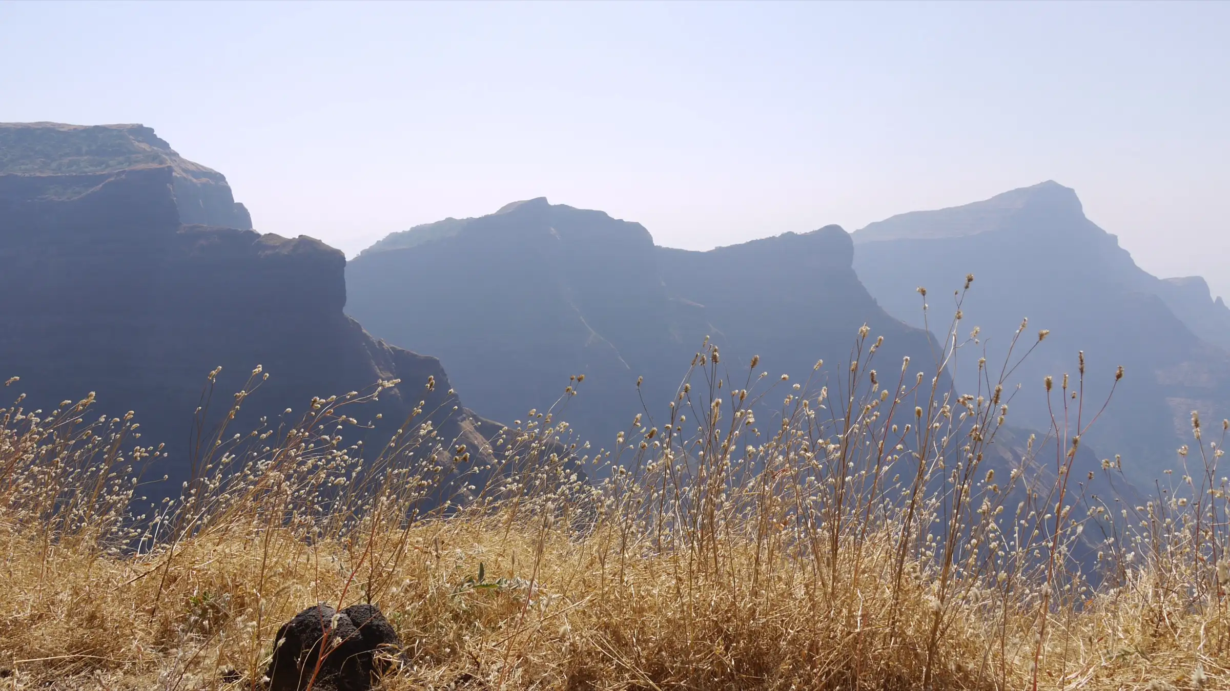 Sheer flat-topped ridges in the haze, looking south from Ratangad about 4 km from Ajobagad (surrounding area, not the trek itself)