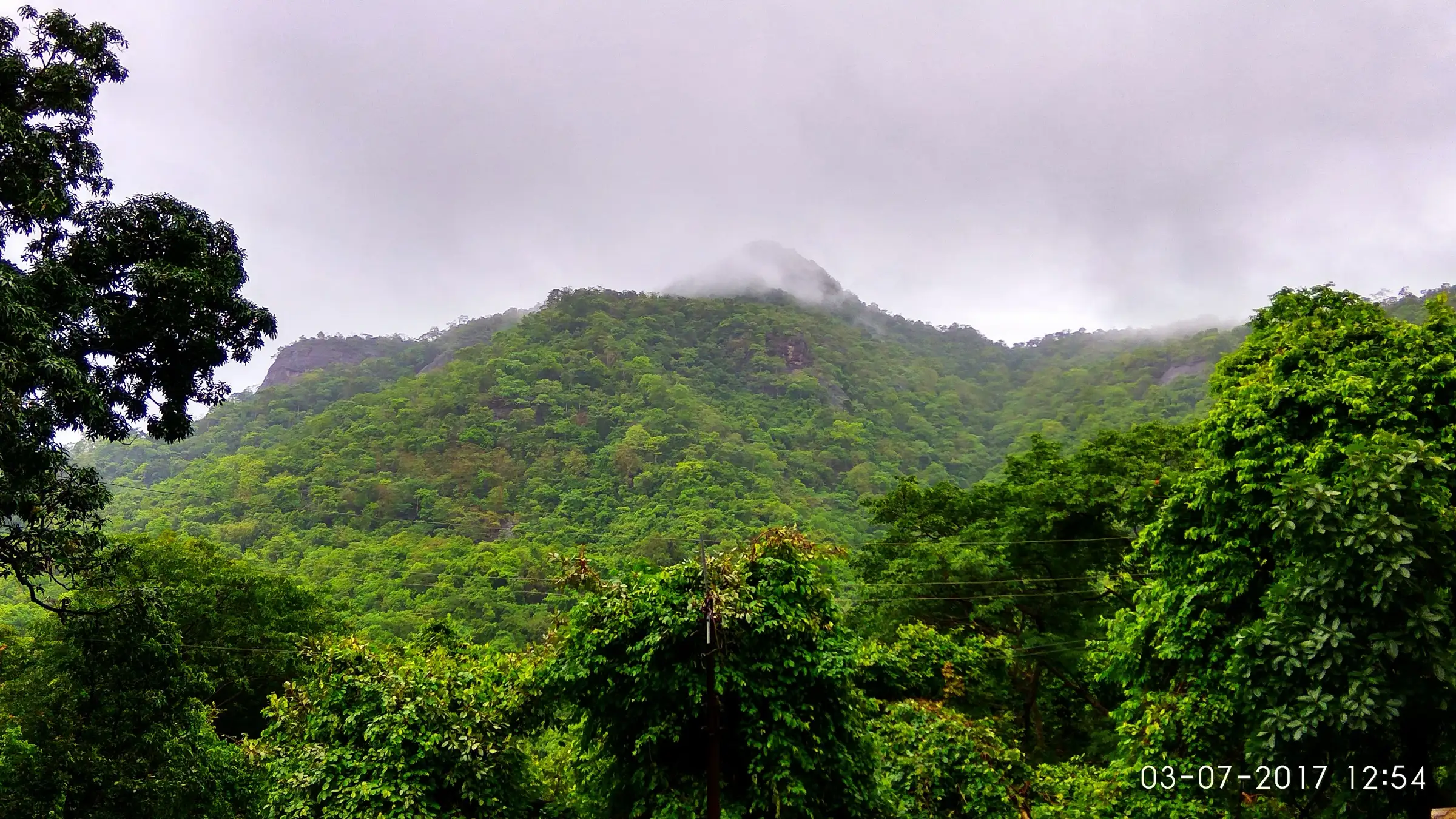 Forested hills wrapped in monsoon cloud, seen from near the Waghoba temple at Waghoba Khind, the start of the Kaldurg trek